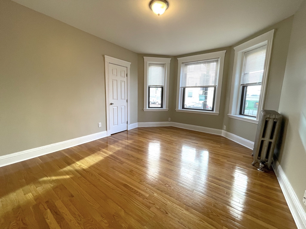 660 Huntington Avenue, Unit 14 Boston, MA 02115 - Photo 3 of 19 a view of an empty room with window and wooden floor