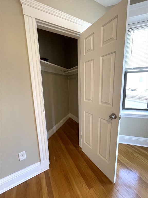 660 Huntington Avenue, Unit 14 Boston, MA 02115 - Photo 5 of 19 a view of a hallway with wooden floor and staircase