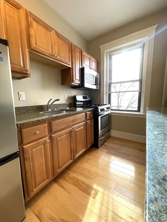 660 Huntington Avenue, Unit 14 Boston, MA 02115 - Photo 8 of 19 a kitchen with stainless steel appliances granite countertop a sink stove and cabinets