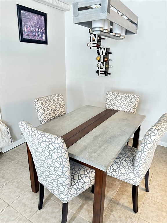 118 Oak Lane, Unit 10 Brockton, MA 02301 - Photo 3 of 6 a view of a room that has a table and chairs