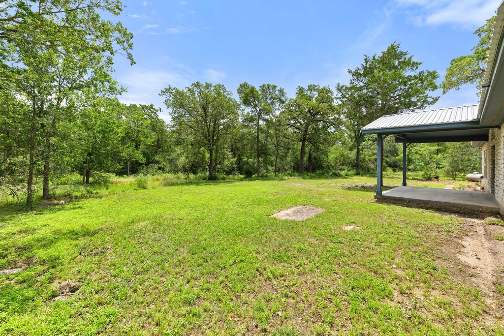 244 Woodway Elgin, TX 78621 - Photo 31 of 40 a view of a garden with a bench