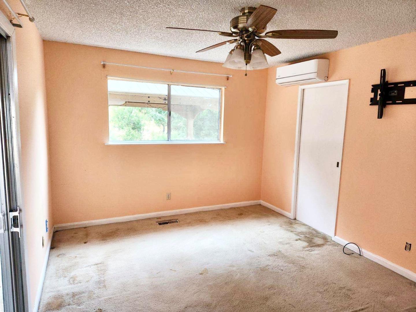 819 Lewis Road Watsonville, CA 95076 - Photo 22 of 32 an empty room with a window and a fan