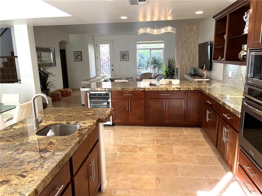 332 5th Street Huntington Beach, CA 92648 - Photo 8 of 11 a large kitchen with stainless steel appliances granite countertop a sink stove and cabinets