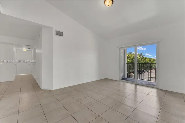 an empty room with windows and outdoor view