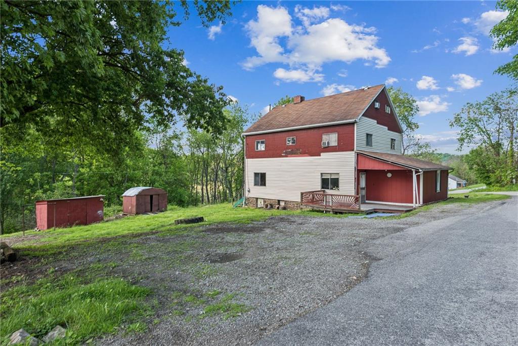375 Reduction Road Smithton, PA 15479 - Photo 29 of 30 a view of a house with a yard and a large tree