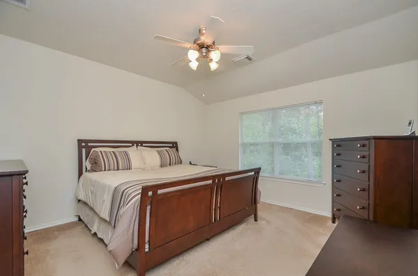 a bed room with a bed and a dresser