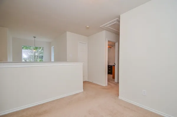 an empty room with windows and closet