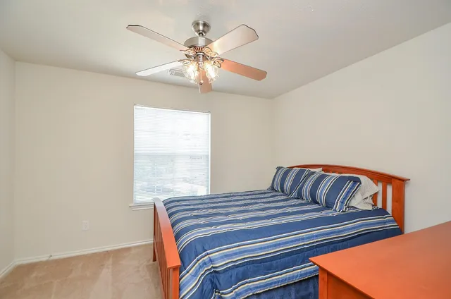 a bedroom with a bed and window