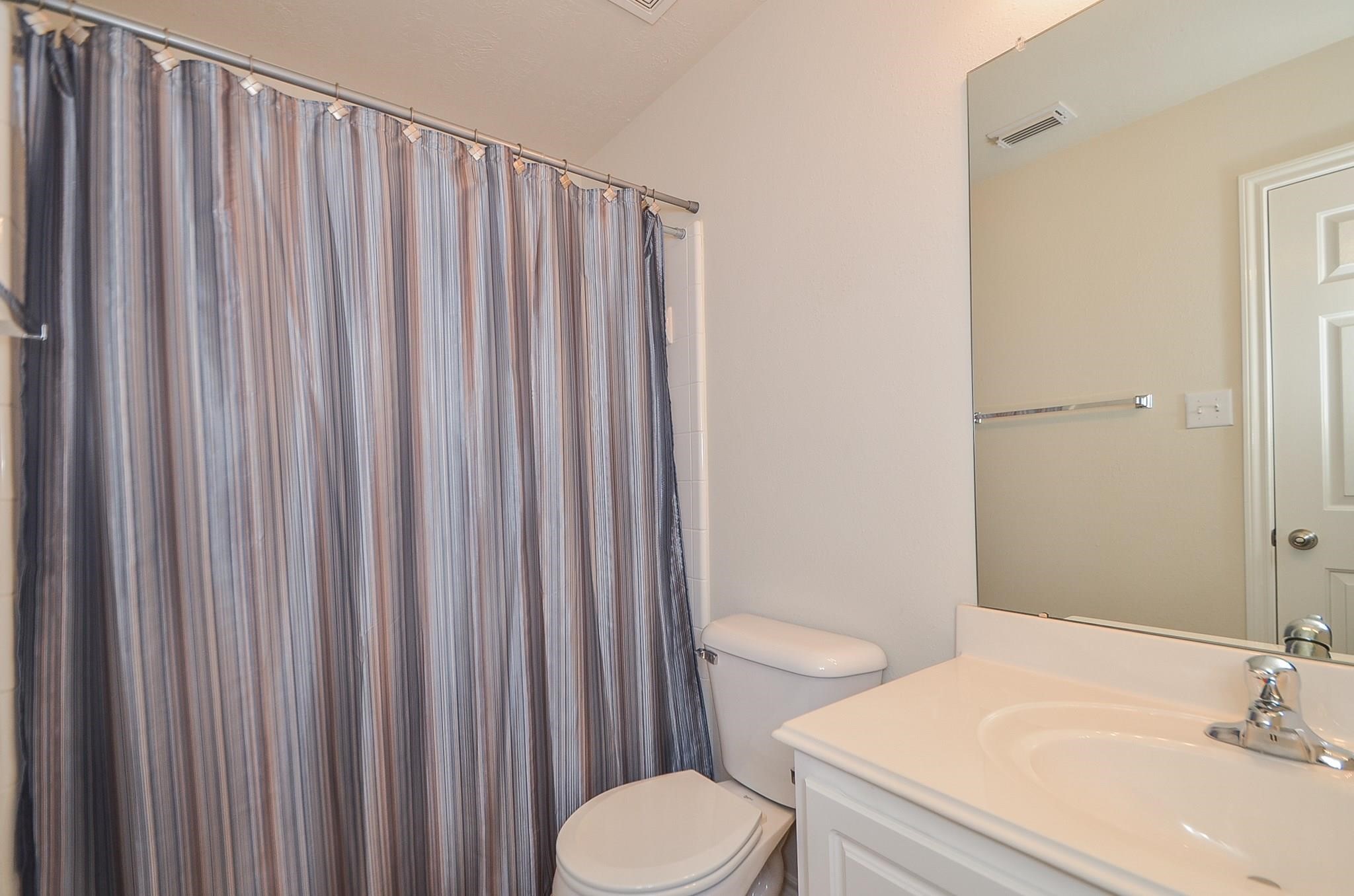 46 East Stedhill Loop Conroe, TX 77384 - Photo 27 of 32 a bathroom with a sink and a toilet