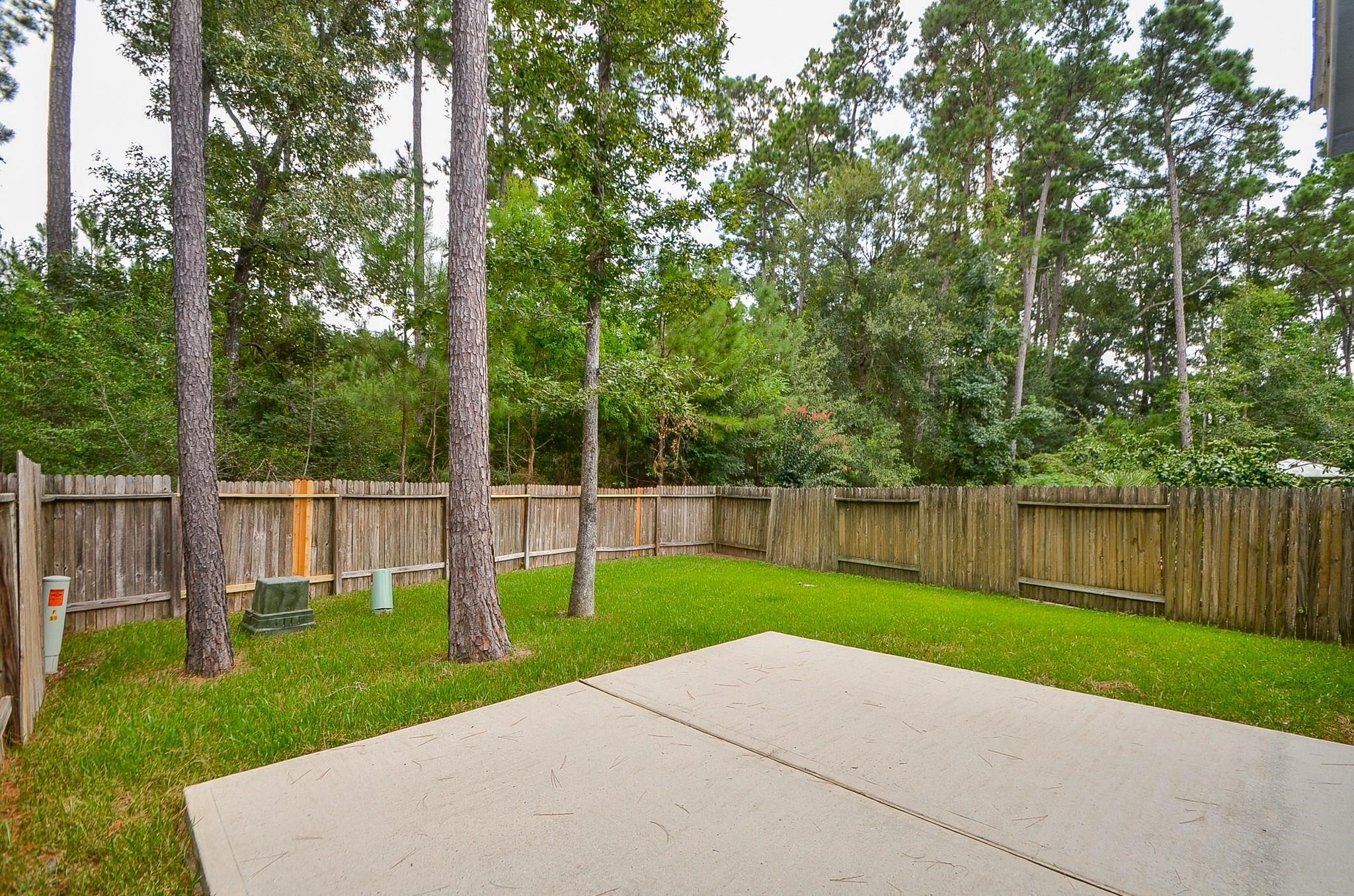 46 East Stedhill Loop Conroe, TX 77384 - Photo 29 of 32 a view of a park with large trees and a barn in it