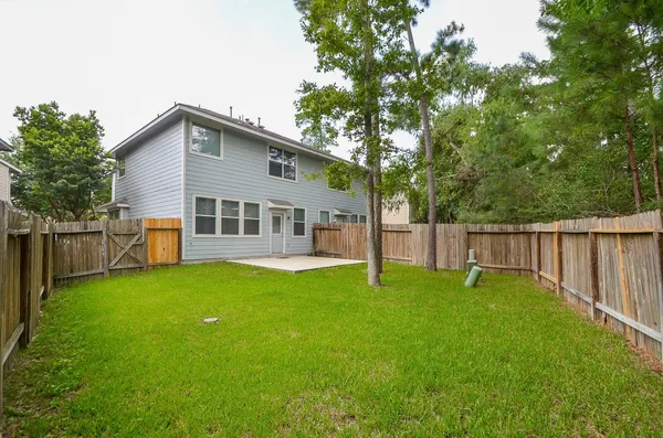 a view of a house with a yard and deck