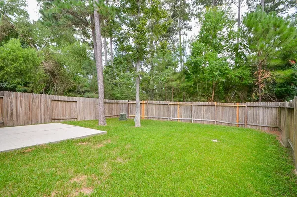 a view of a yard with a wooden fence