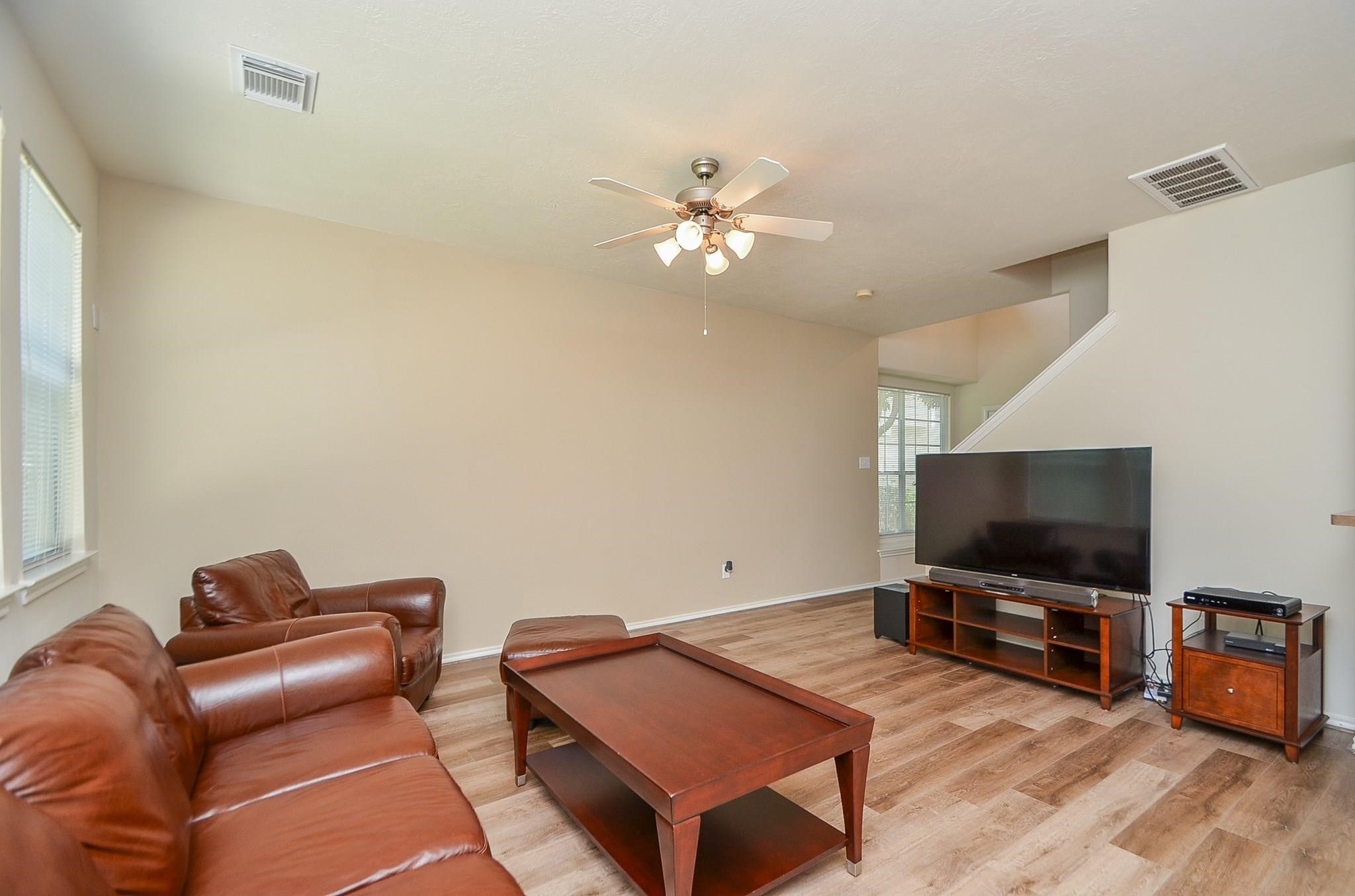 46 East Stedhill Loop Conroe, TX 77384 - Photo 8 of 32 a living room with furniture and a flat screen tv
