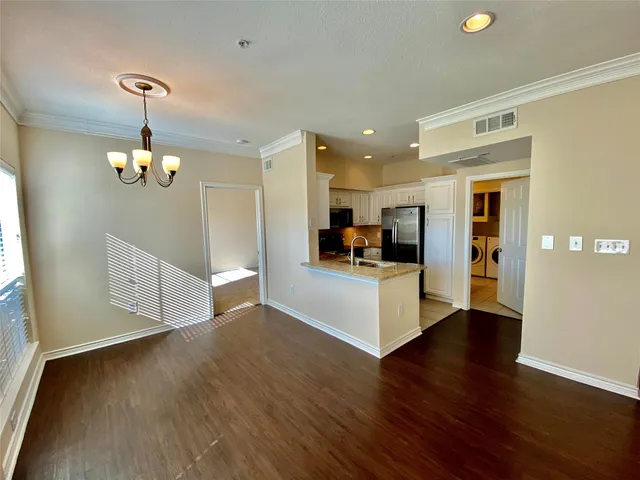a view of a kitchen with furniture and wooden floor