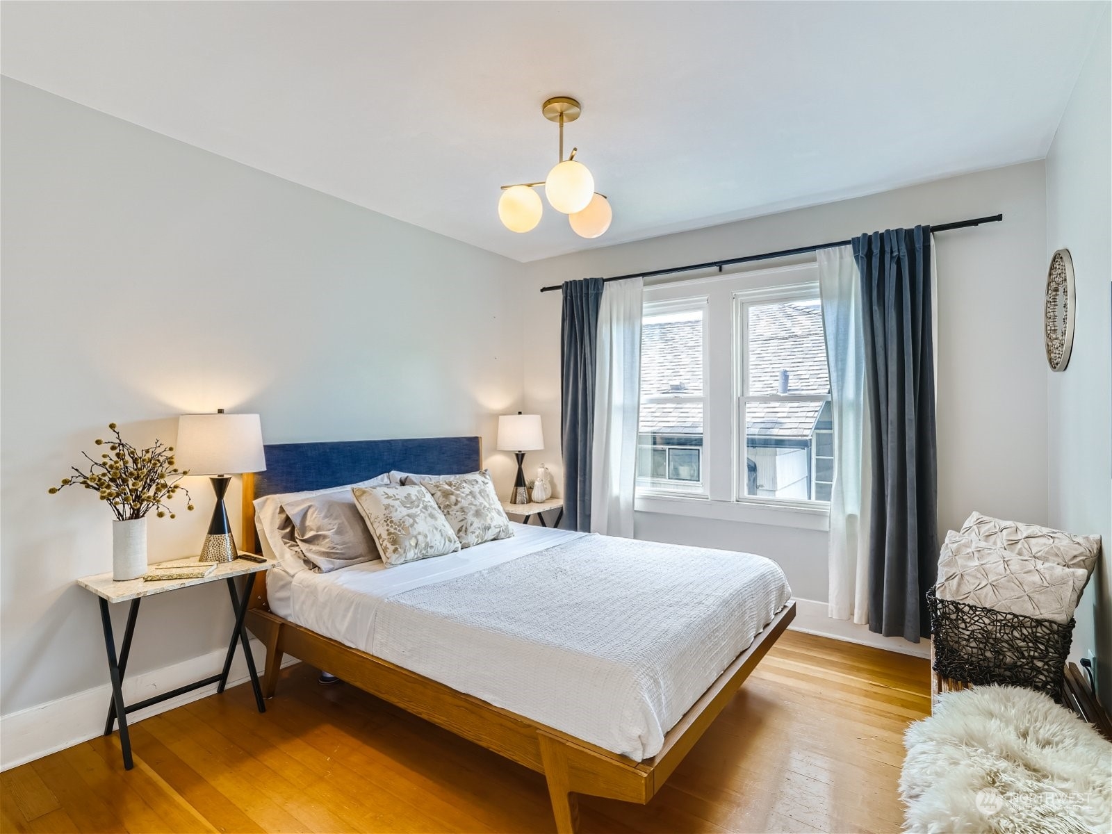 3032 Walnut Avenue Southwest Seattle, WA 98116 - Photo 12 of 29 a bedroom with a bed and a chandelier