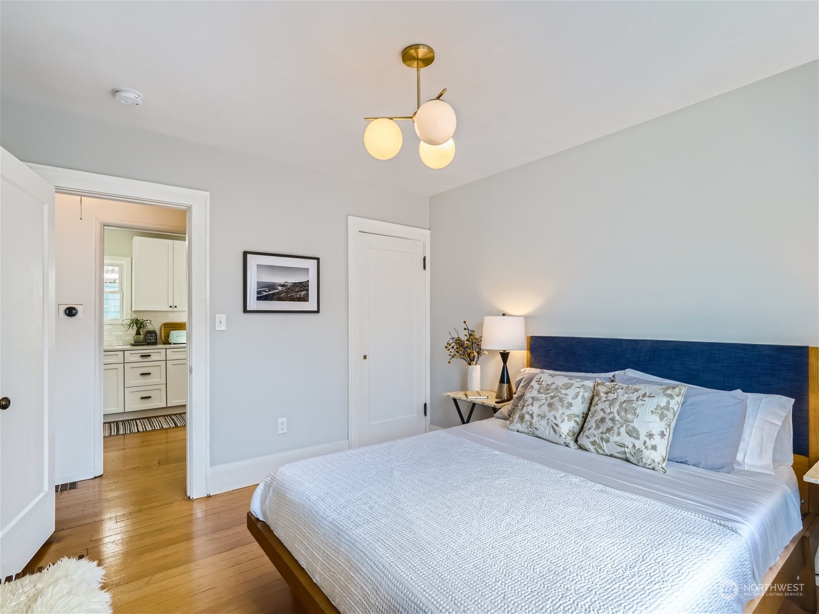 3032 Walnut Avenue Southwest Seattle, WA 98116 - Photo 13 of 29 a bedroom with a bed and wooden floor