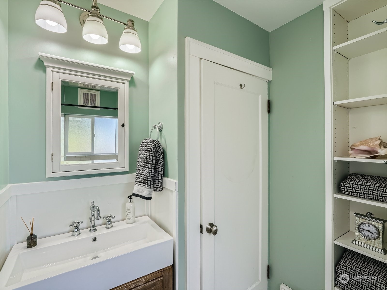 3032 Walnut Avenue Southwest Seattle, WA 98116 - Photo 15 of 29 a bathroom with a sink and a mirror
