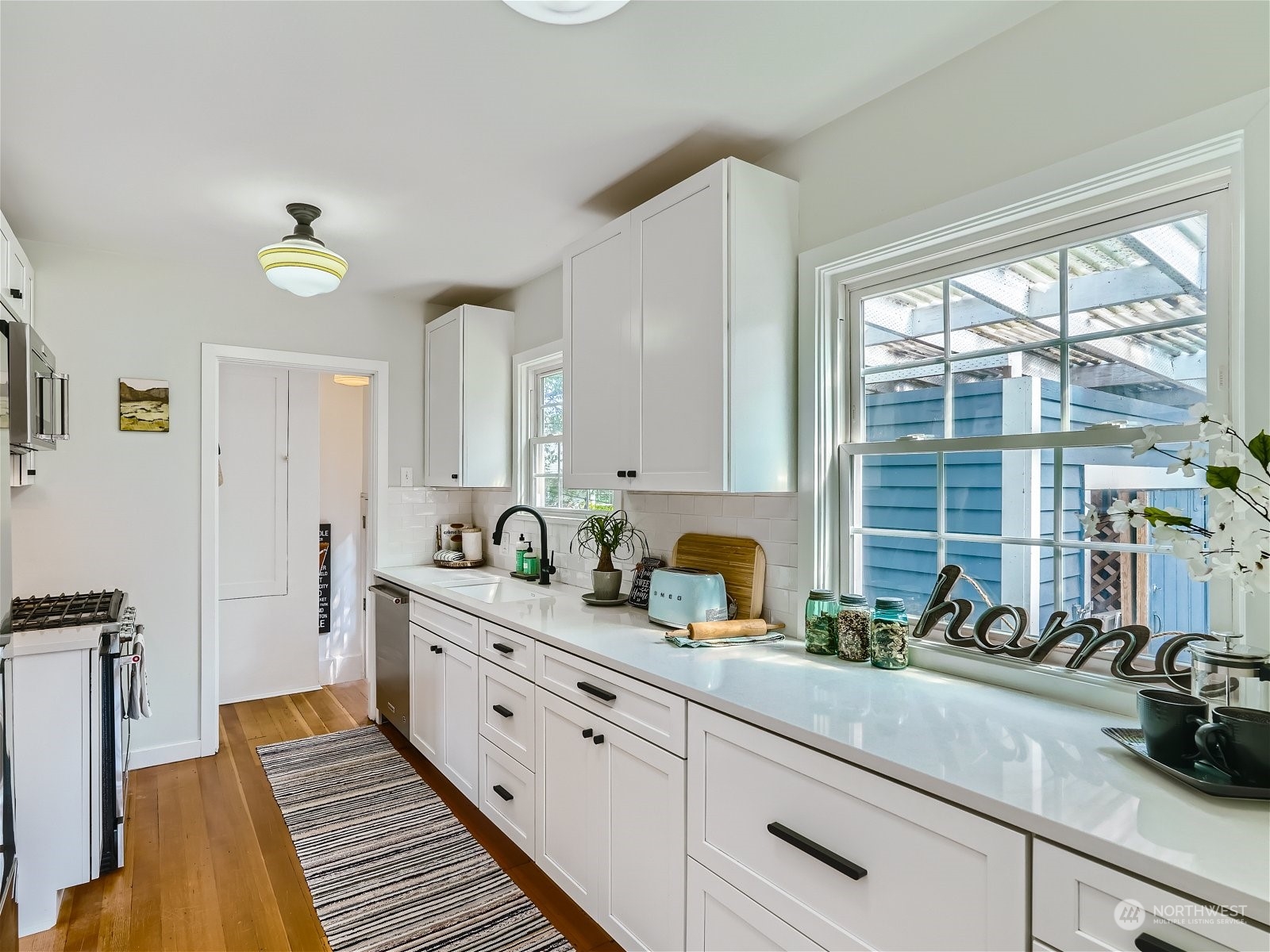 3032 Walnut Avenue Southwest Seattle, WA 98116 - Photo 6 of 29 a kitchen with sink and cabinets