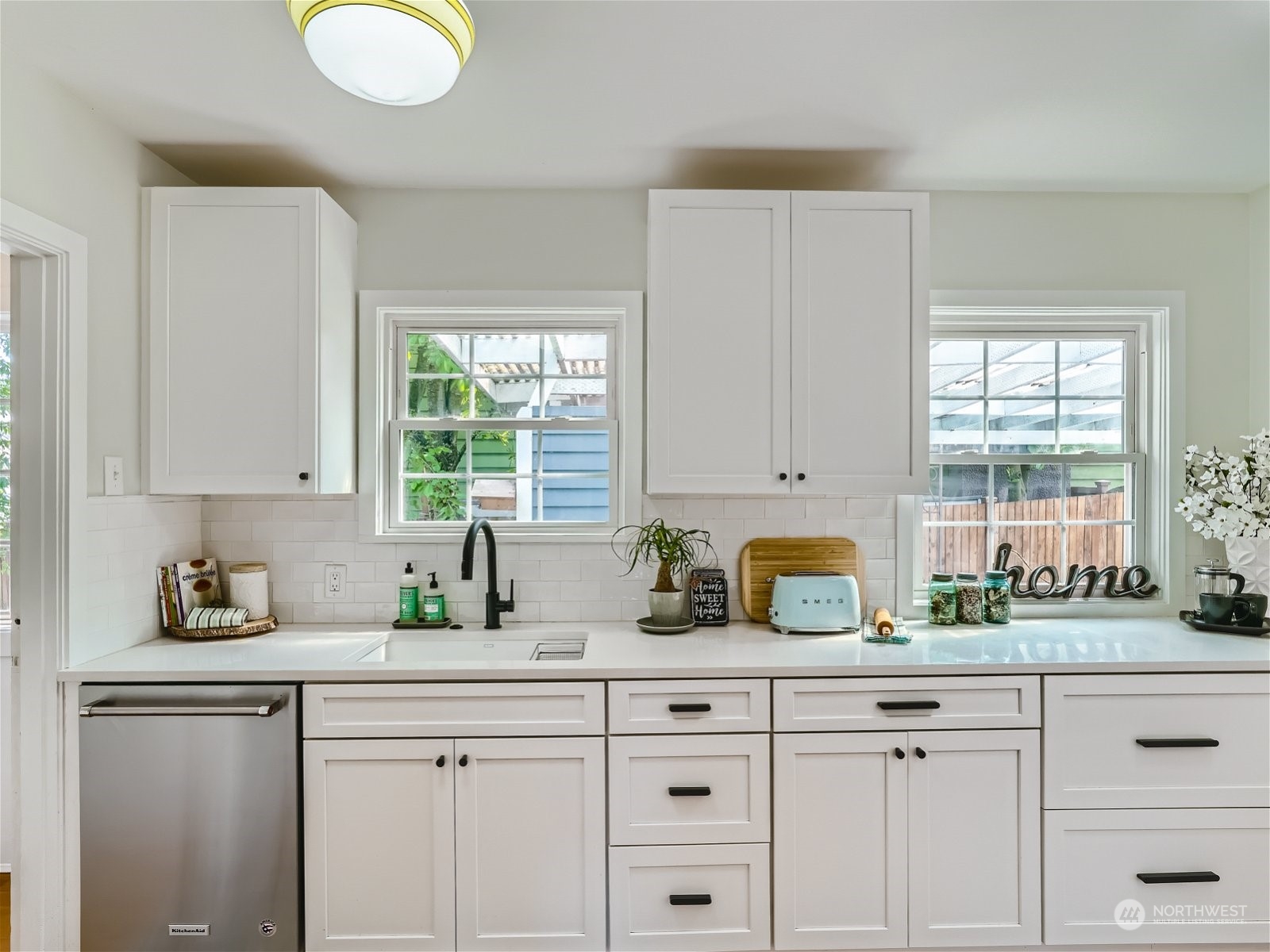 3032 Walnut Avenue Southwest Seattle, WA 98116 - Photo 7 of 29 a kitchen with a sink window and cabinets