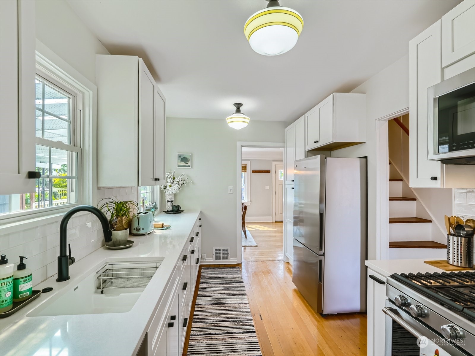 3032 Walnut Avenue Southwest Seattle, WA 98116 - Photo 8 of 29 a kitchen with stainless steel appliances granite countertop a sink stove and refrigerator