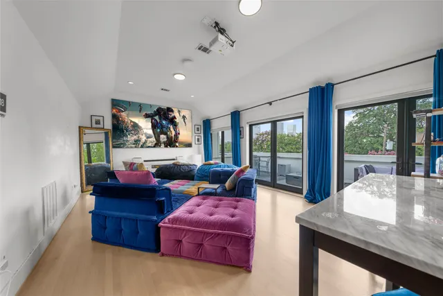 a living room with furniture and a floor to ceiling window