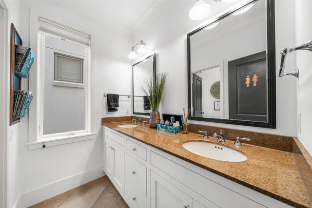 a bathroom with a tub shower and mirror