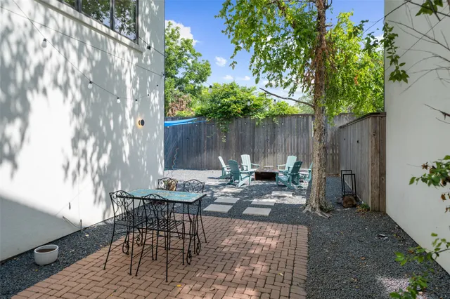 a view of backyard of house with seating space
