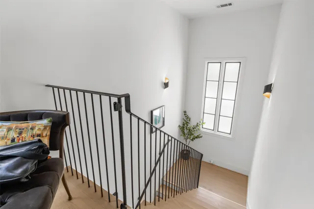a view of a hallway with windows and stairs