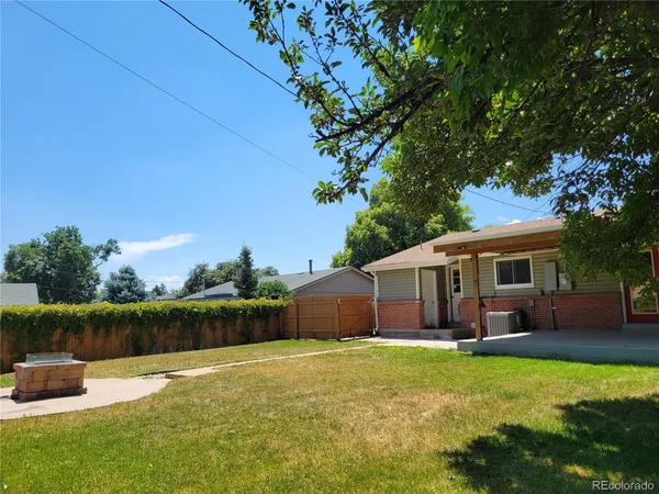 a front view of a house with garden and a patio