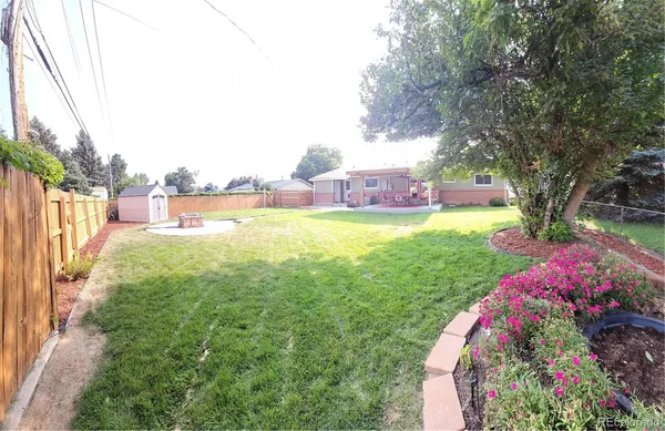 a view of a garden with a house
