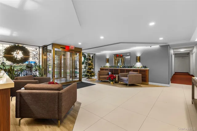 a living room with furniture a floor to ceiling window and a flat screen tv