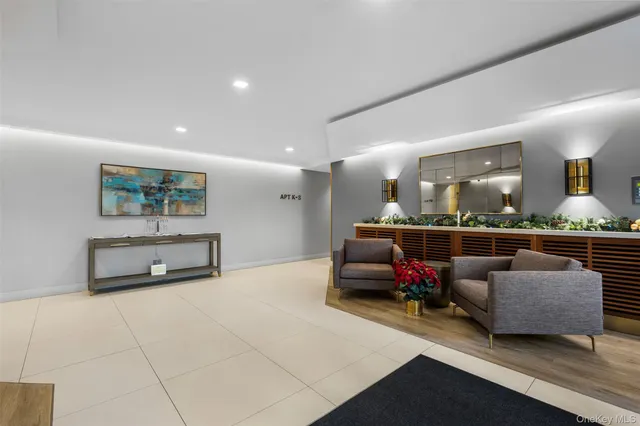 a living room with furniture a flat screen tv and a large window