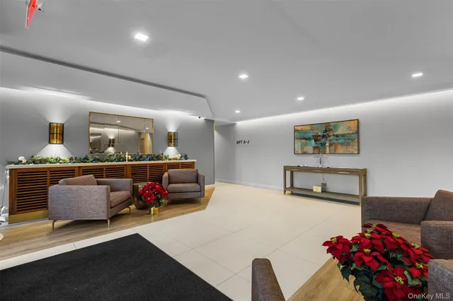 a living room with furniture and flowers