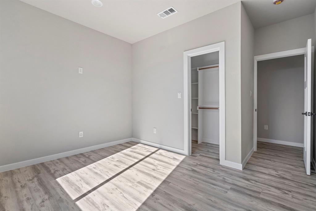 948 Corinth Street, Unit 1 Dallas, TX 75215 - Photo 15 of 27 a view of an empty room and wooden floor