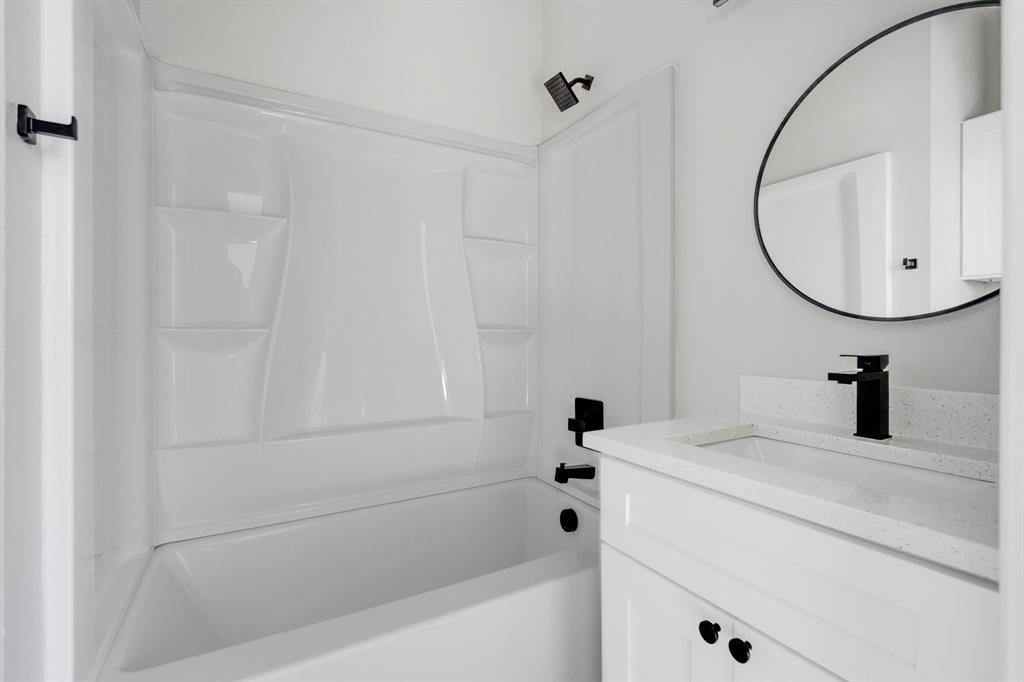 948 Corinth Street, Unit 1 Dallas, TX 75215 - Photo 17 of 27 a bathroom with a sink and a mirror