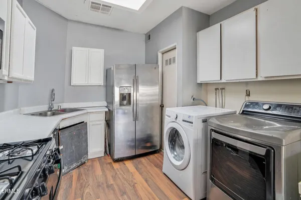 a kitchen with a stove top oven sink and cabinets