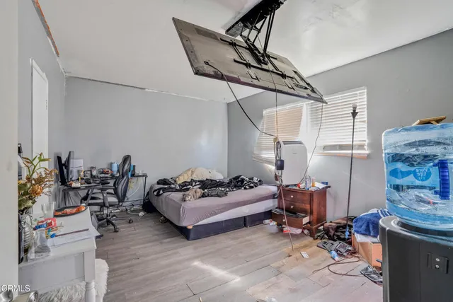 a living room with furniture cabinets and a window