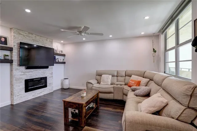 a living room with furniture fireplace and flat screen tv