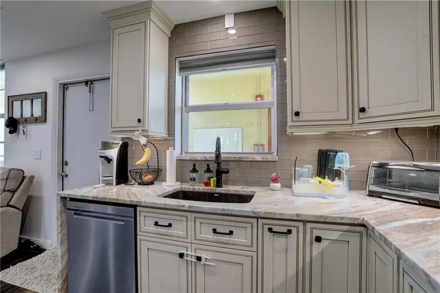 a kitchen with sink cabinets and a granite counter top