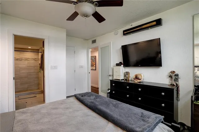 a living room with flat screen tv and dresser