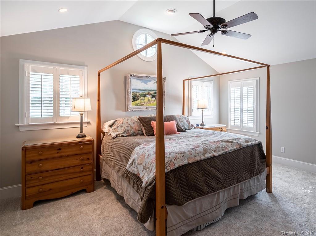 3200 Wickersham Road Charlotte, NC 28211 - Photo 13 of 40 a bedroom with a bed a dresser and a window