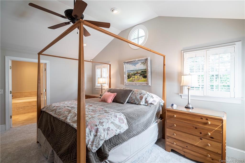 3200 Wickersham Road Charlotte, NC 28211 - Photo 14 of 40 a bedroom with a bed and wooden floor