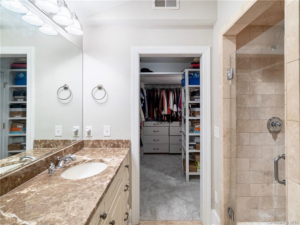3200 Wickersham Road Charlotte, NC 28211 - Photo 17 of 40 a bathroom with a granite countertop sink a mirror and shower