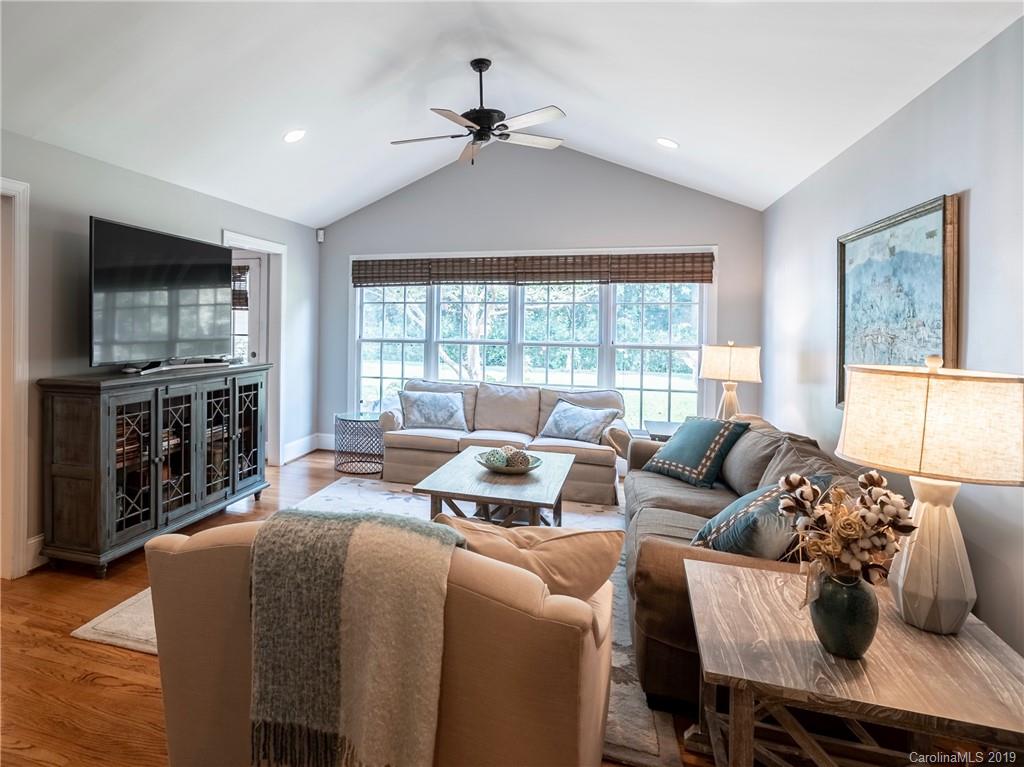 3200 Wickersham Road Charlotte, NC 28211 - Photo 3 of 40 a living room with furniture a flat screen tv and a large window