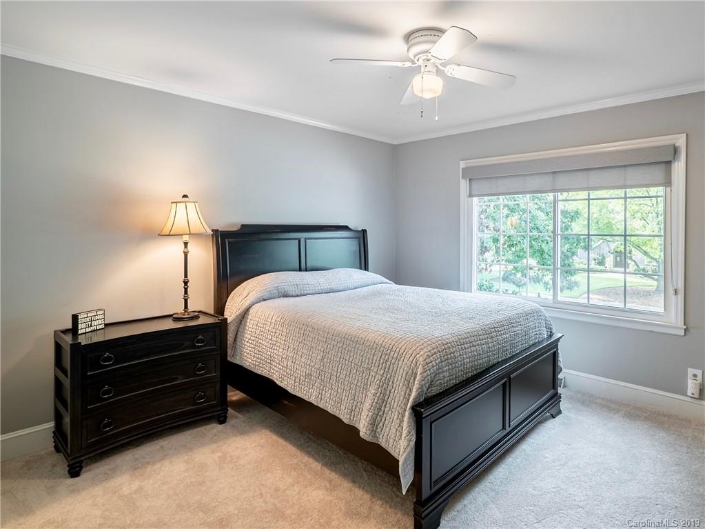 3200 Wickersham Road Charlotte, NC 28211 - Photo 24 of 40 a bed room with a bed and a chandelier