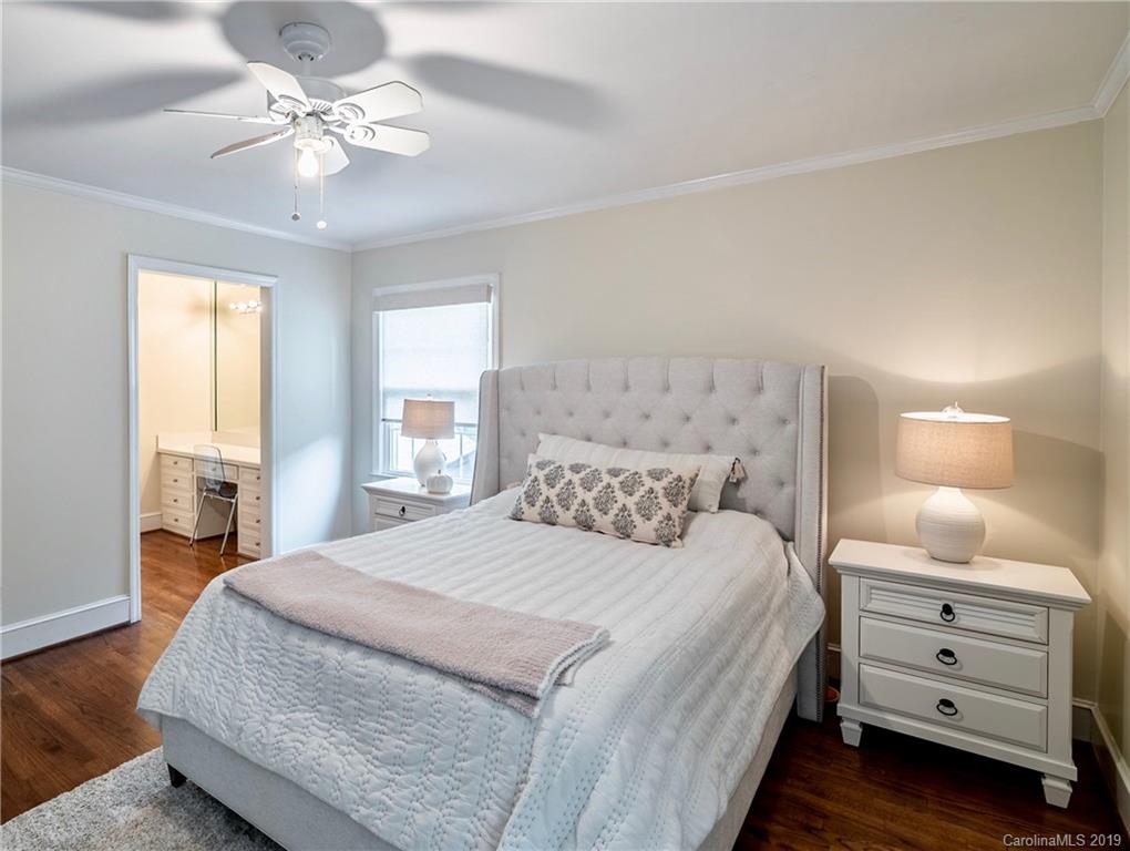 3200 Wickersham Road Charlotte, NC 28211 - Photo 26 of 40 a bedroom with a bed and a chandelier
