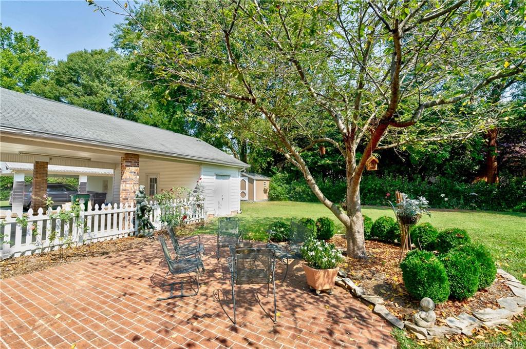 3200 Wickersham Road Charlotte, NC 28211 - Photo 30 of 40 a view of a chair and table in backyard