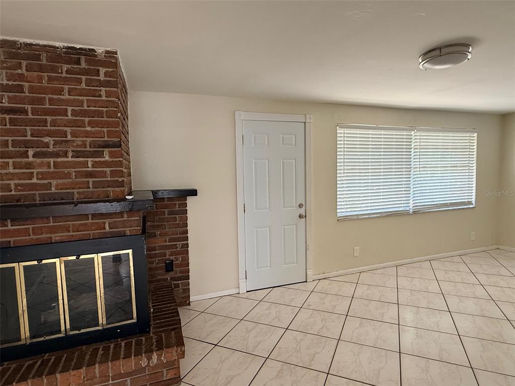 3704 36th Street West Bradenton, FL 34205 - Photo 12 of 34 a view of an empty room with window and brick wall