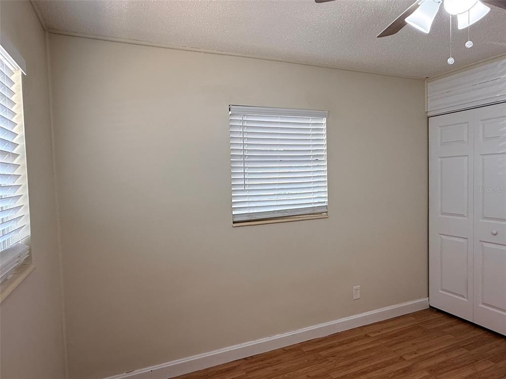 3704 36th Street West Bradenton, FL 34205 - Photo 17 of 34 an empty room with wooden floor and windows