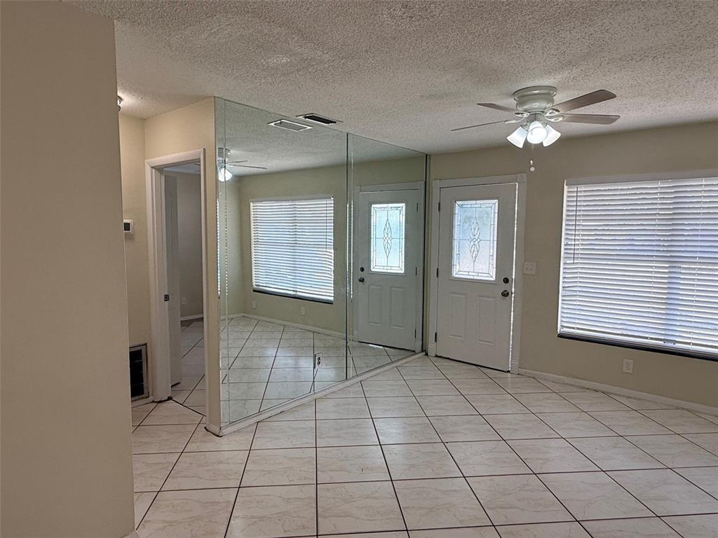3704 36th Street West Bradenton, FL 34205 - Photo 5 of 34 a view of an empty room with window and chandelier fan